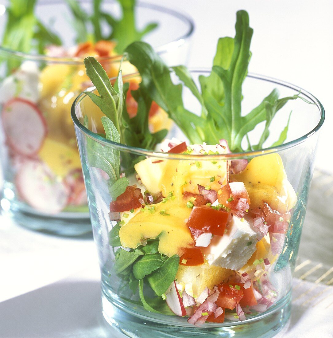 Cheese salad with rocket in glasses