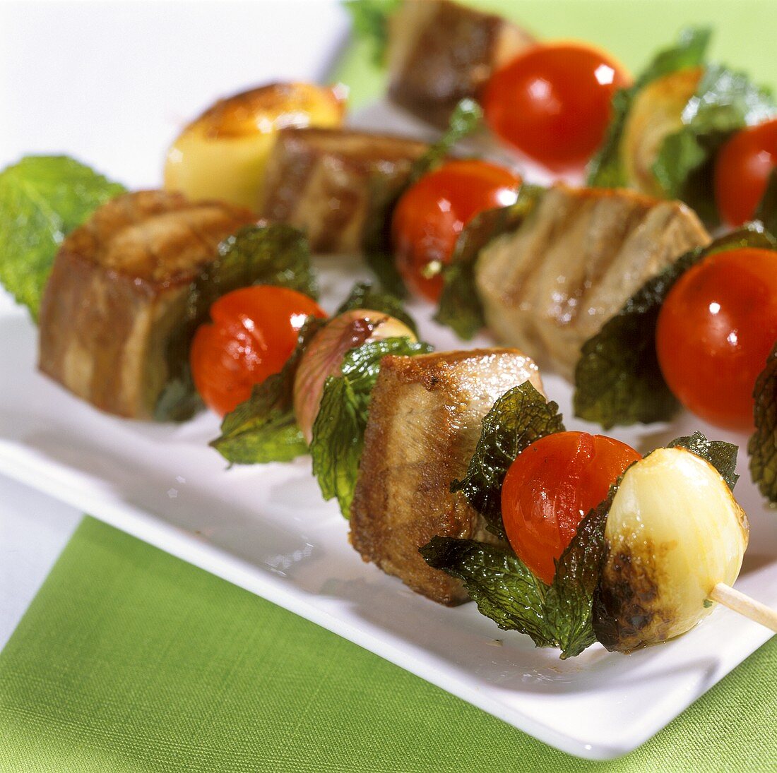 Barbecued tuna kebabs with cherry tomatoes and mint