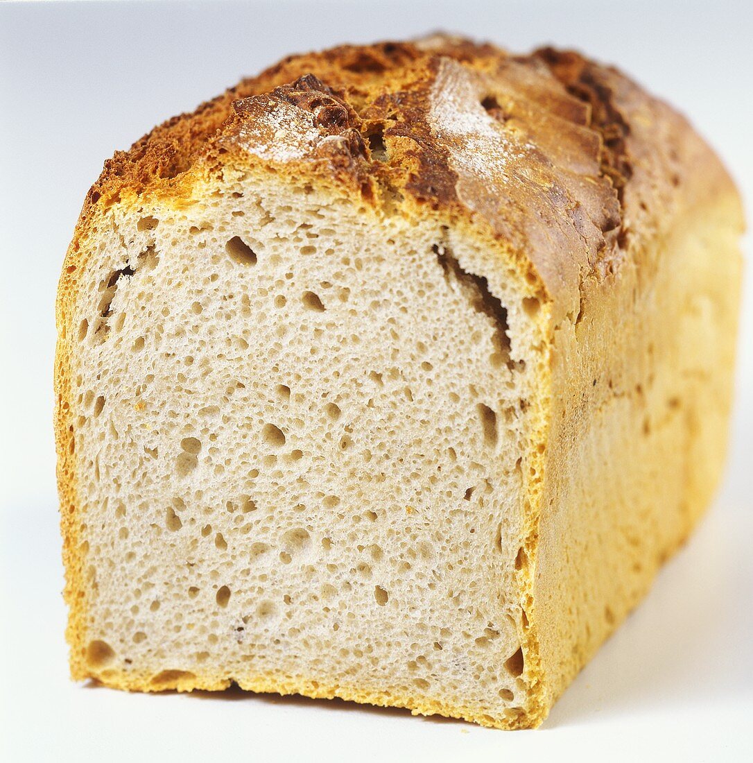 Rustic tin loaf, a slice cut