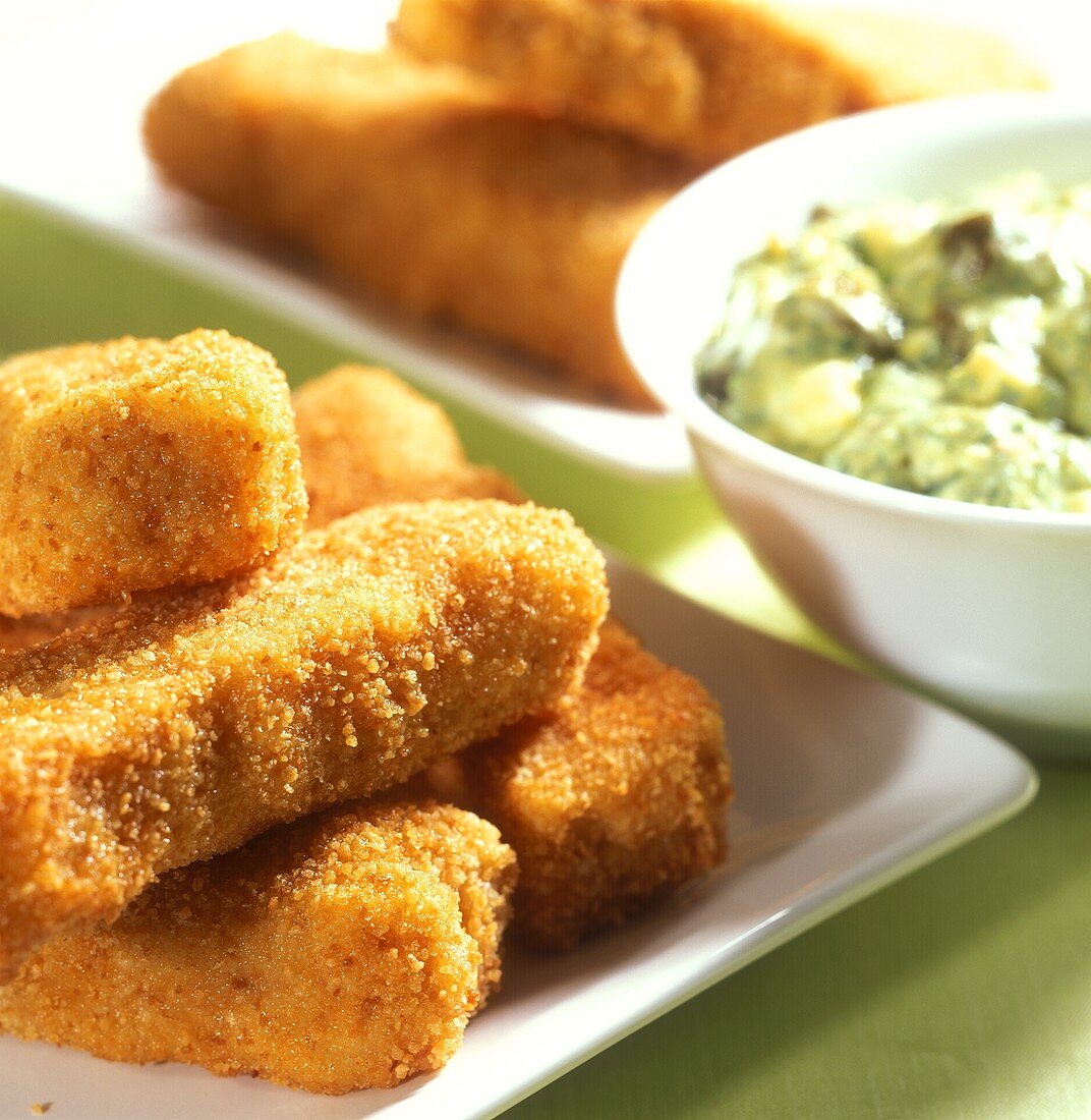 Fish fingers with green herb and caper sauce