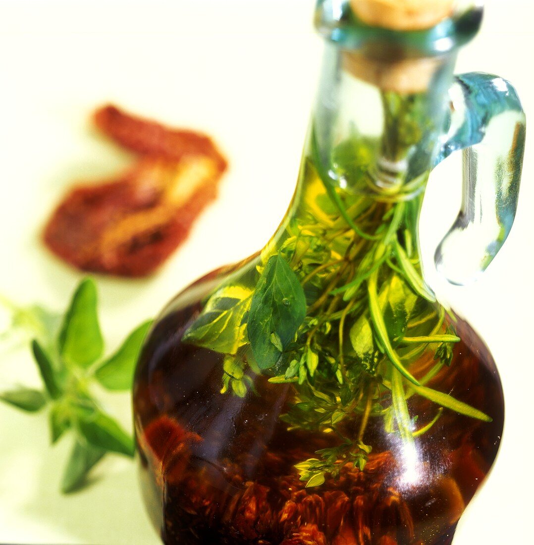 Home-made tomato and herb oil in bottle