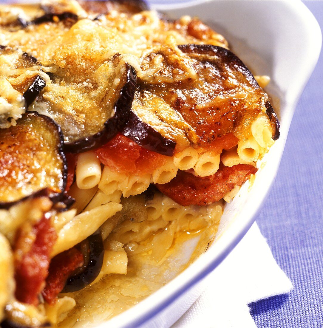 Macaroni and sausage bake with aubergines in baking dish