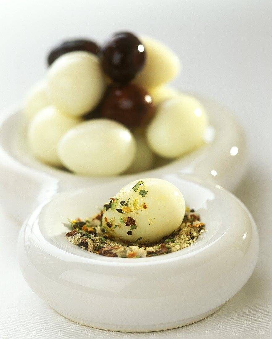 Quail's eggs with olives and spicy dip