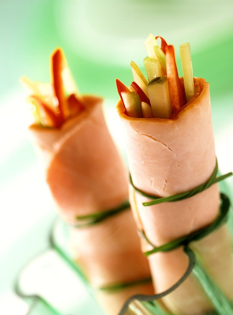 Ham and vegetable rolls, tied with chives