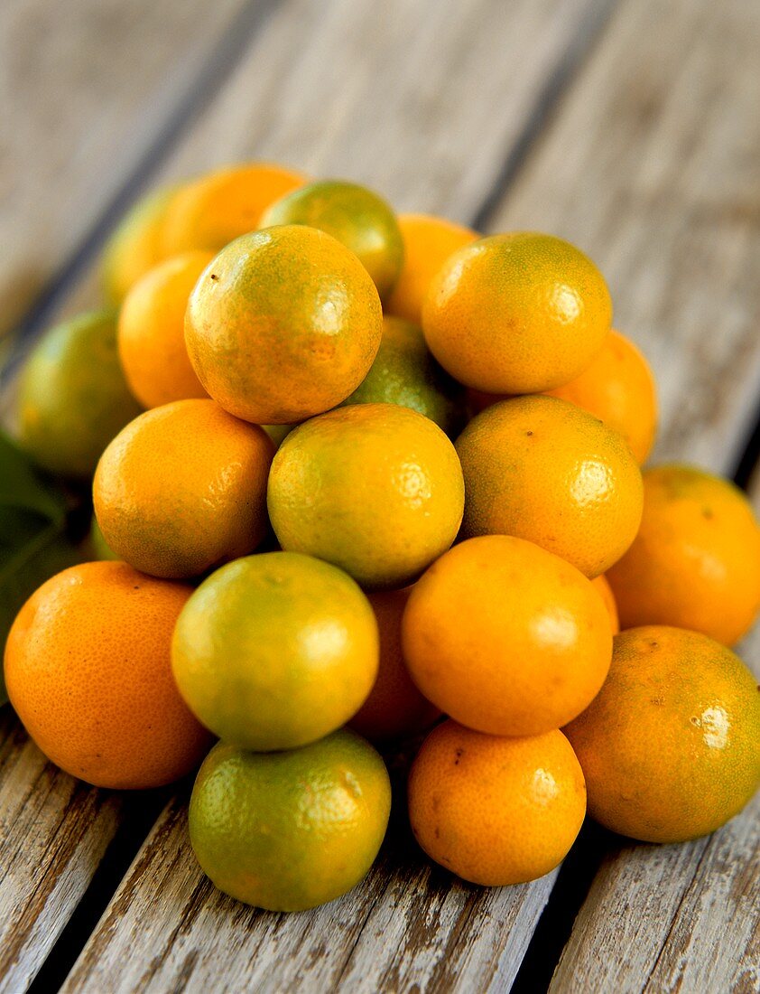 Kumquats on wooden background