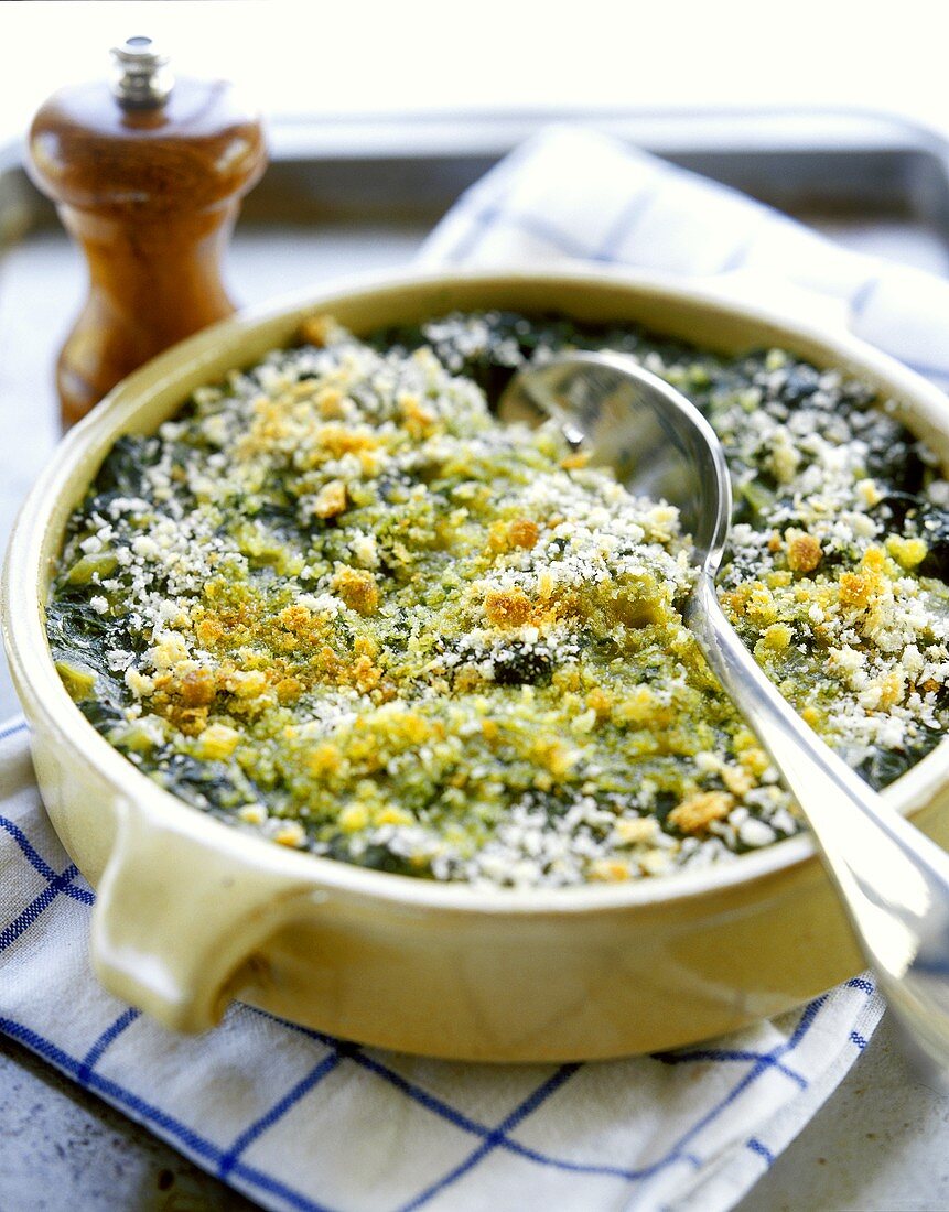 Spinach gratin in cup with spoon