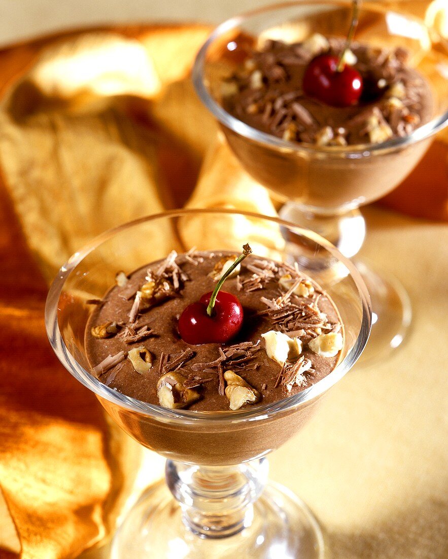 Chocolate mousse, decorated with nuts and cherry