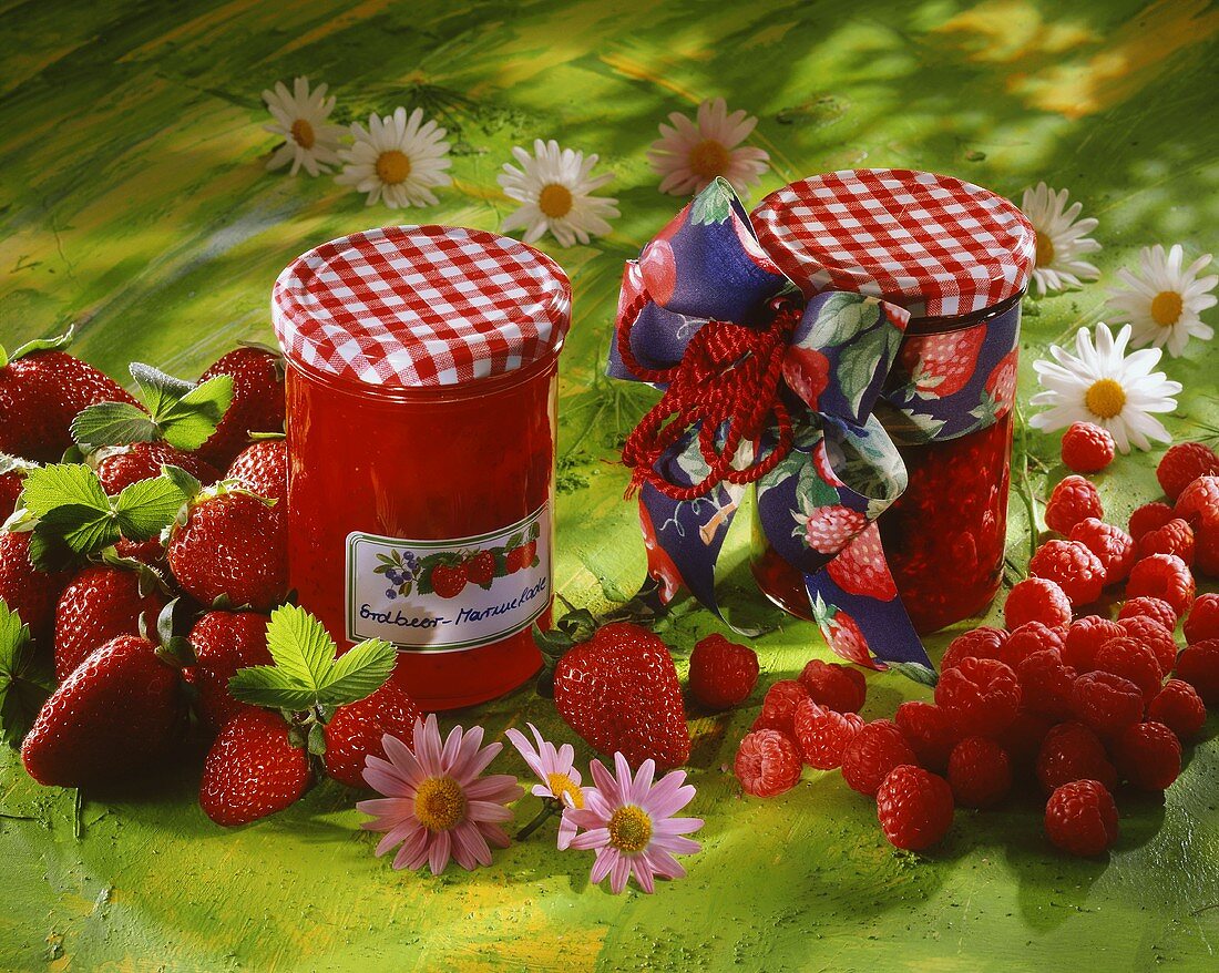 Strawberry- and raspberry jam in jars