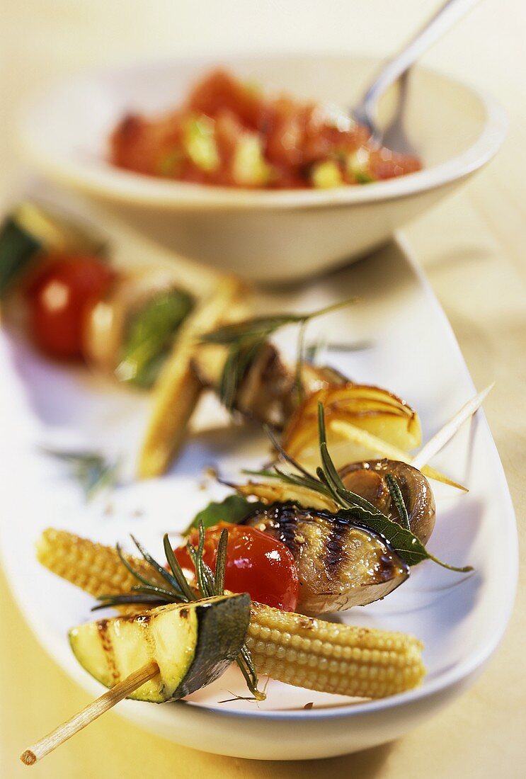 Barbecued vegetable kebabs with rosemary; tomato salsa
