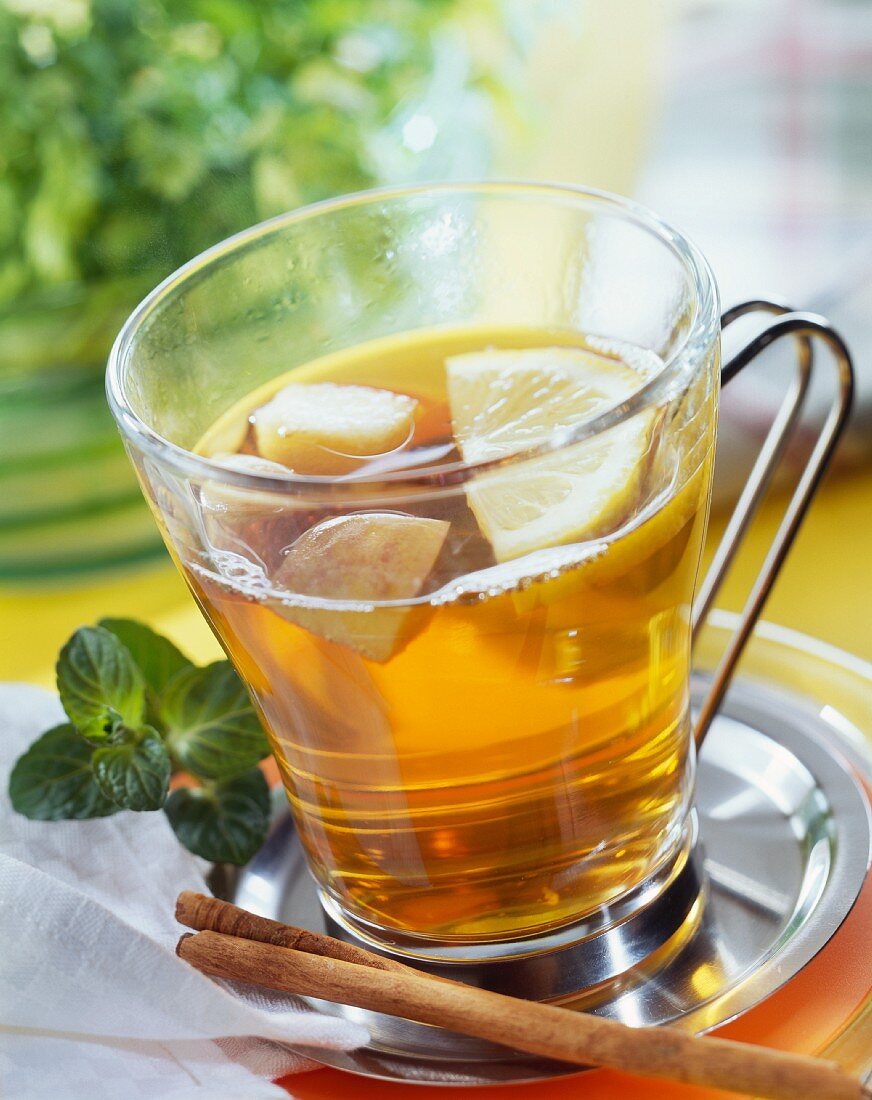Apple and herb tea punch in glass cup