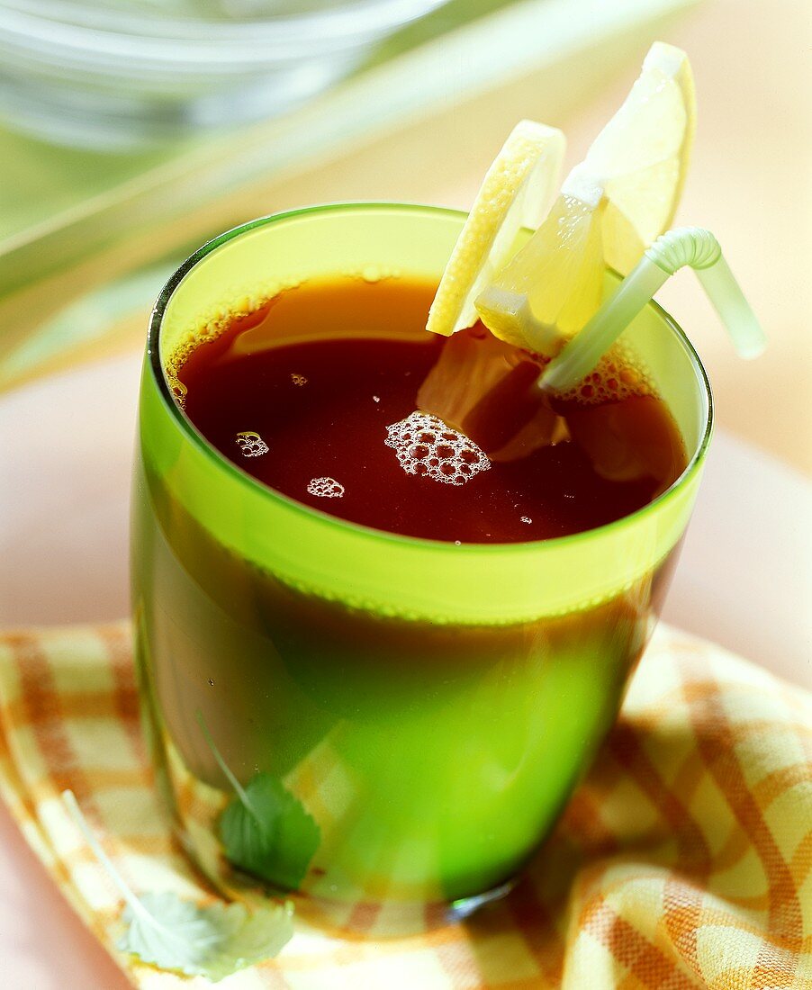 Red wine punch in green glass with lemon slices