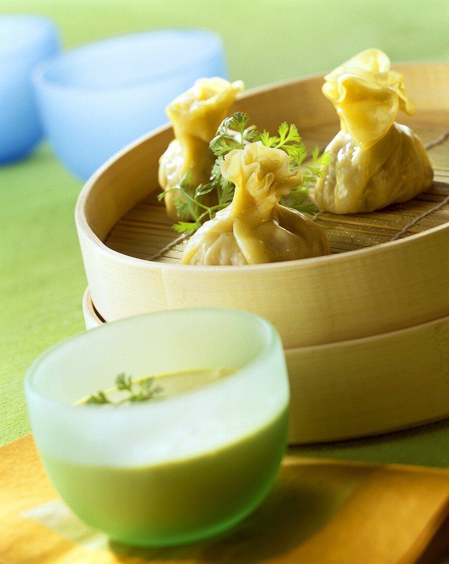 Dim Sum in bamboo steamer; coconut sauce