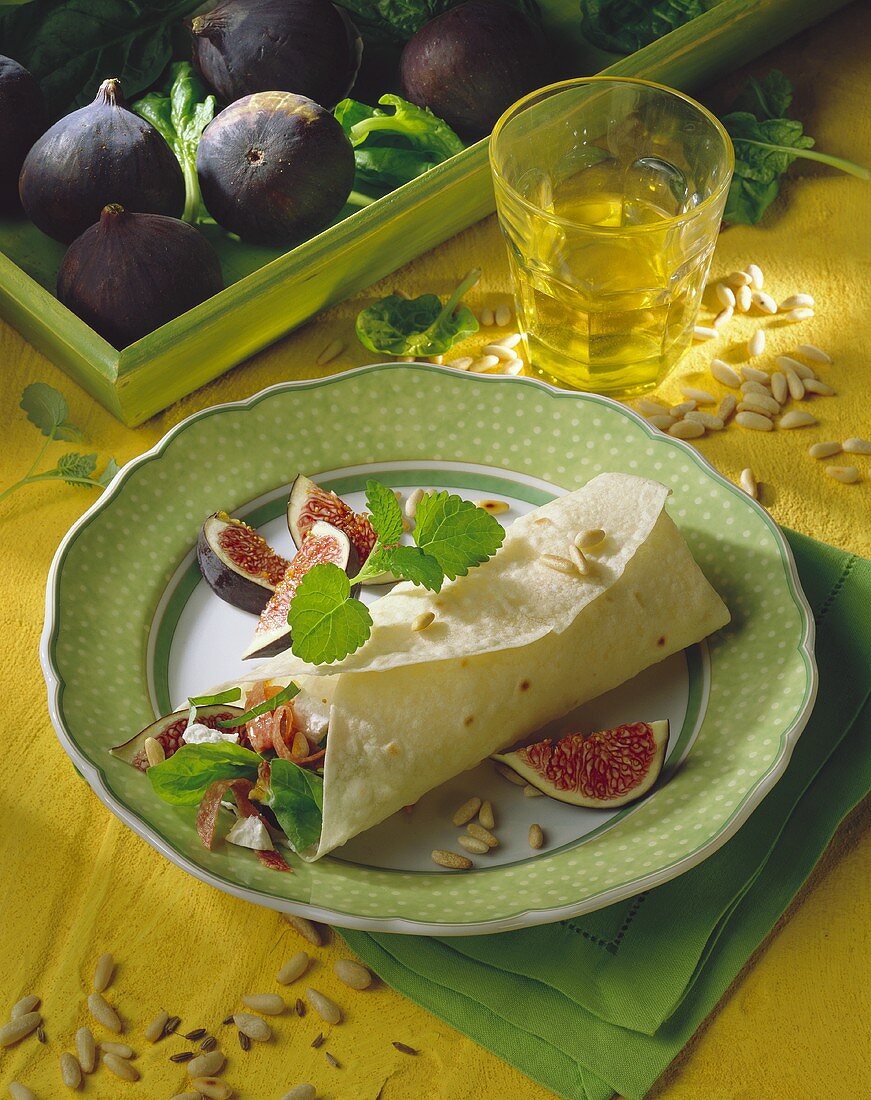 Fig, goat's cheese and salami wrap with pine nuts 