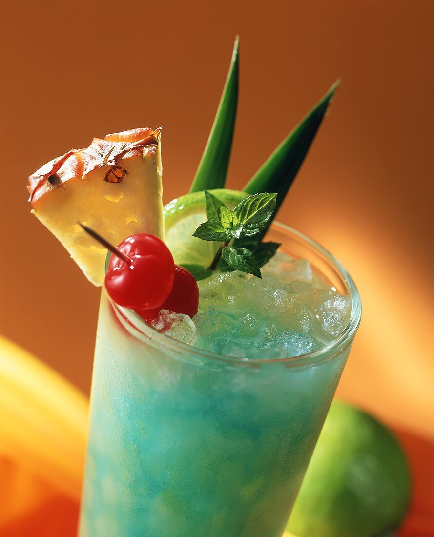 Cocktail with Blue Curacao, exotic fruit and ice cubes