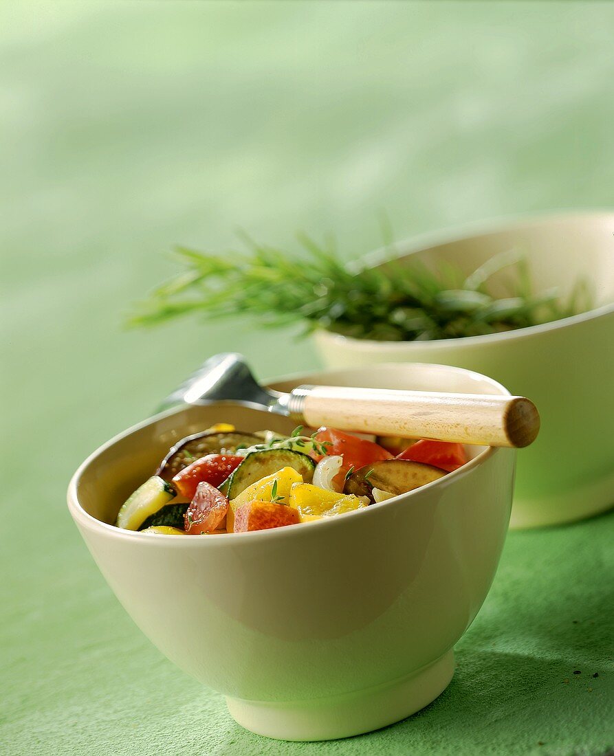 Ratatouille with rosemary in white bowl