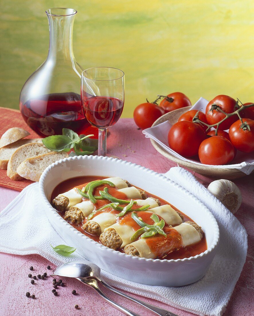 Cannelloni with mince filling in tomato sauce; red wine