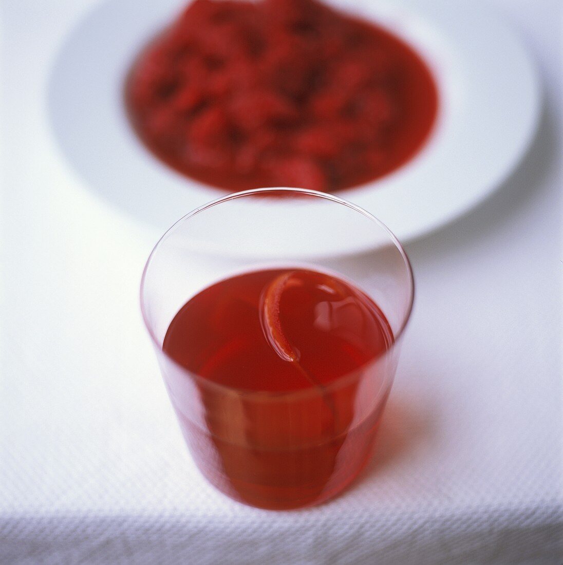 Tamarillo juice in glass; tamarillo compote on plate