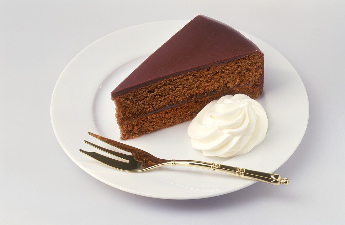 Piece of Sacher torte with cream