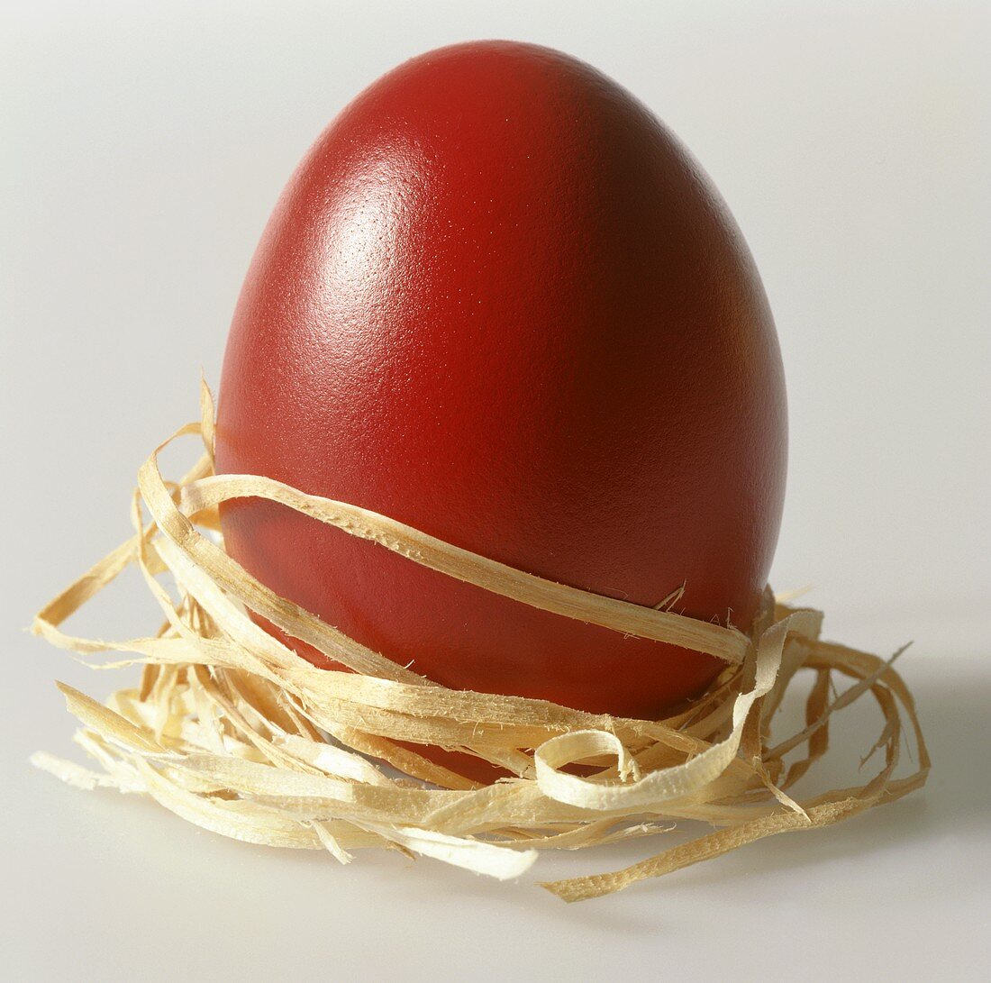 Red egg, wrapped in straw