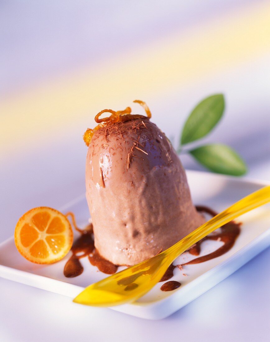 Iced chocolate pudding garnished with kumquat