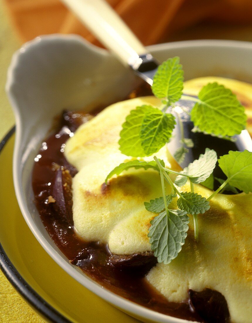 Plum brulee with mint leaves