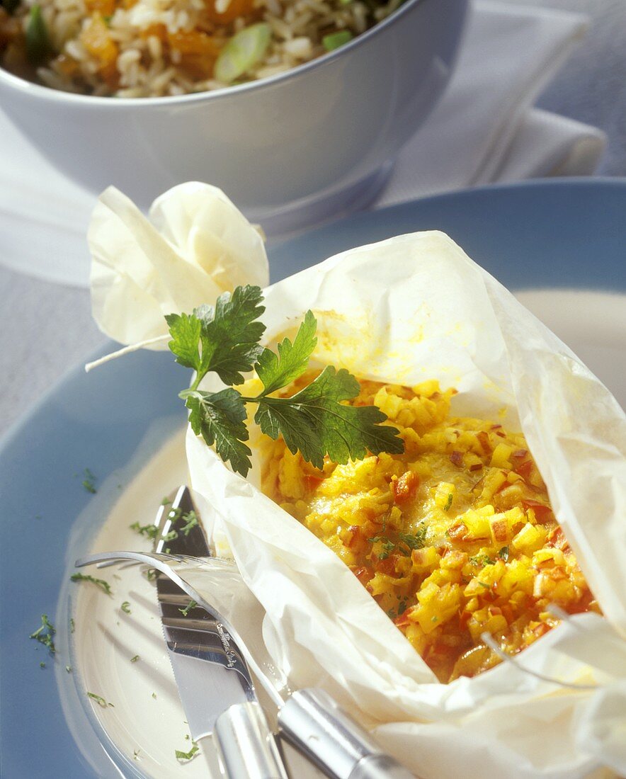Gingered fish in baking paper with rice and apricots