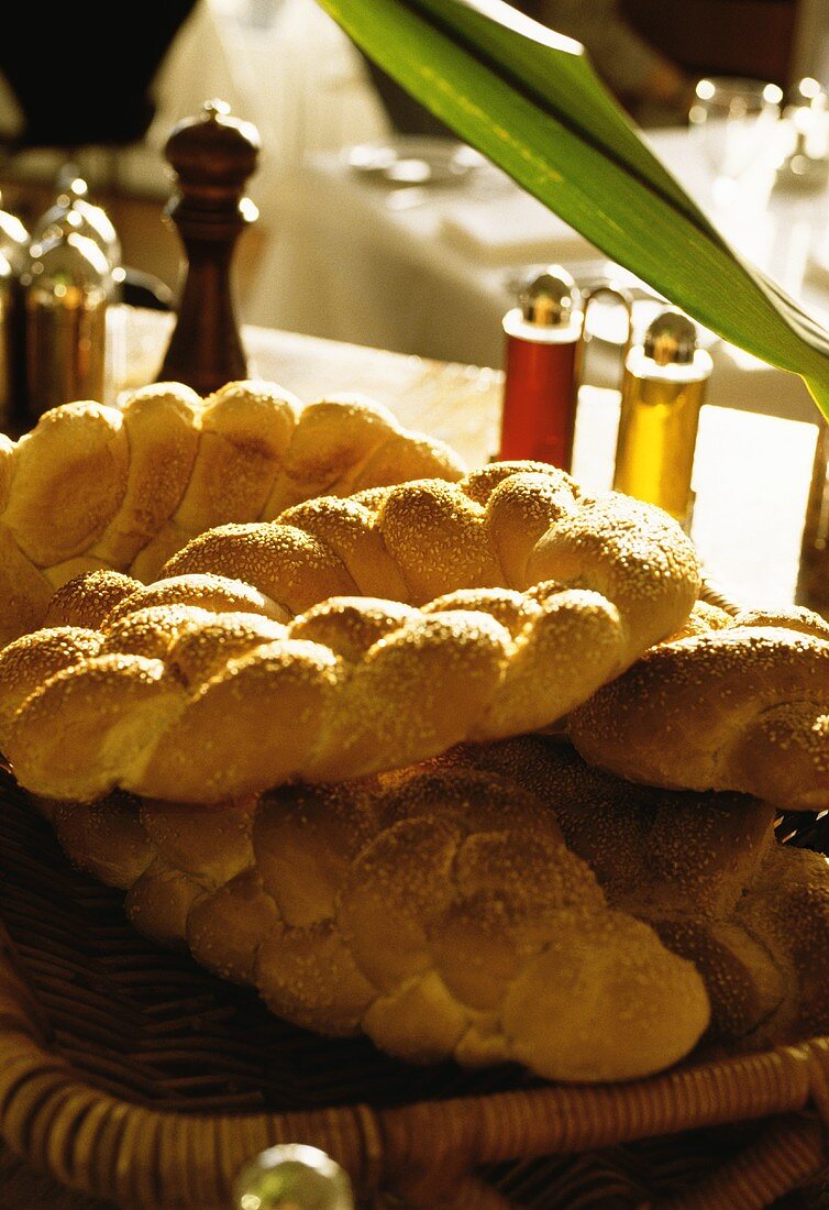 Sesame plait in bread basket on table