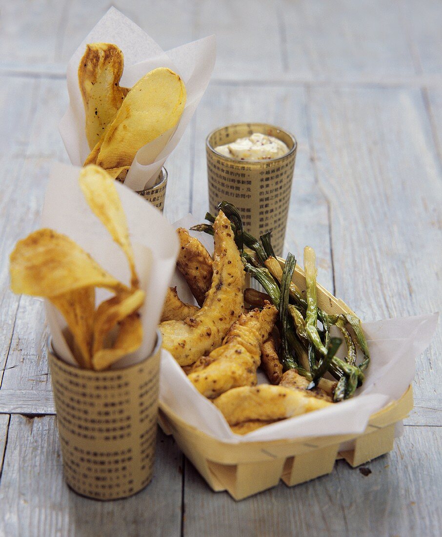 Fish and chips with mustard dip and spring onions