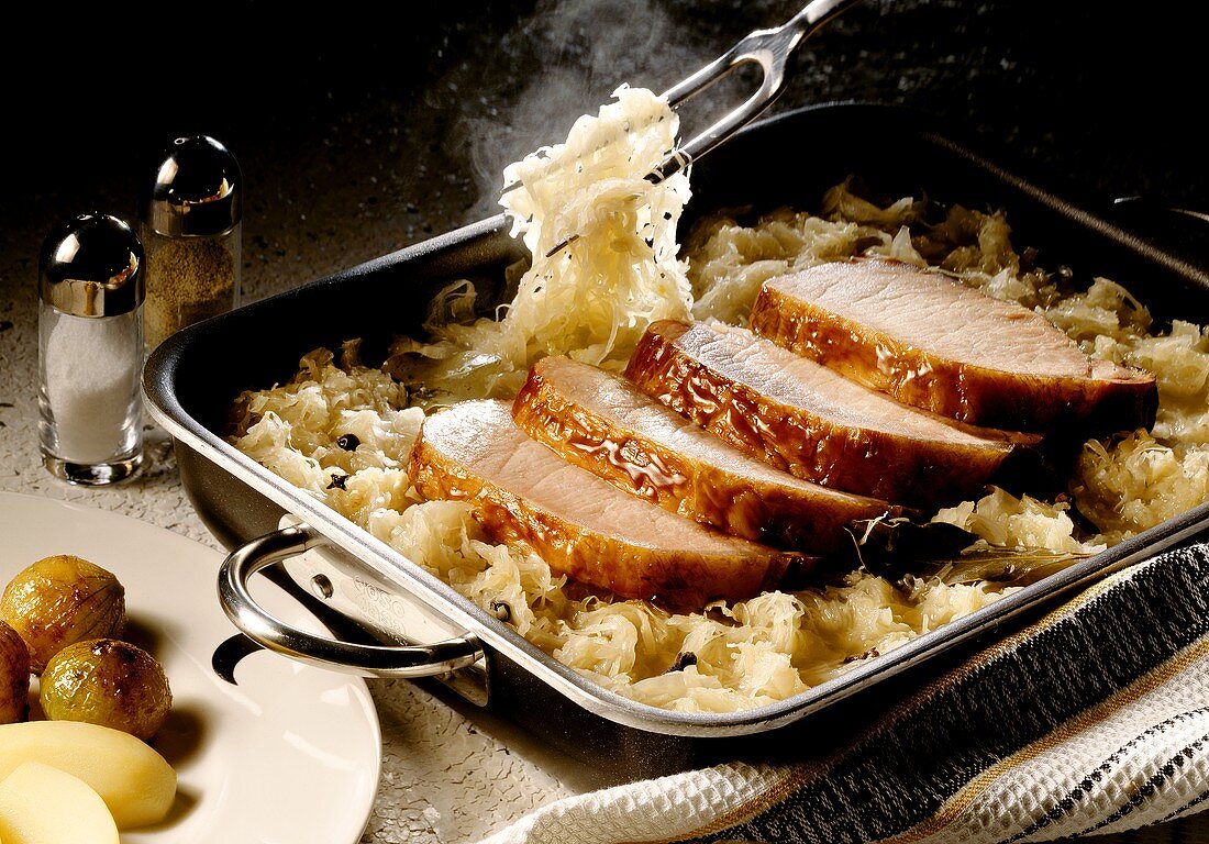 Smoked pork rib with sauerkraut in roasting dish