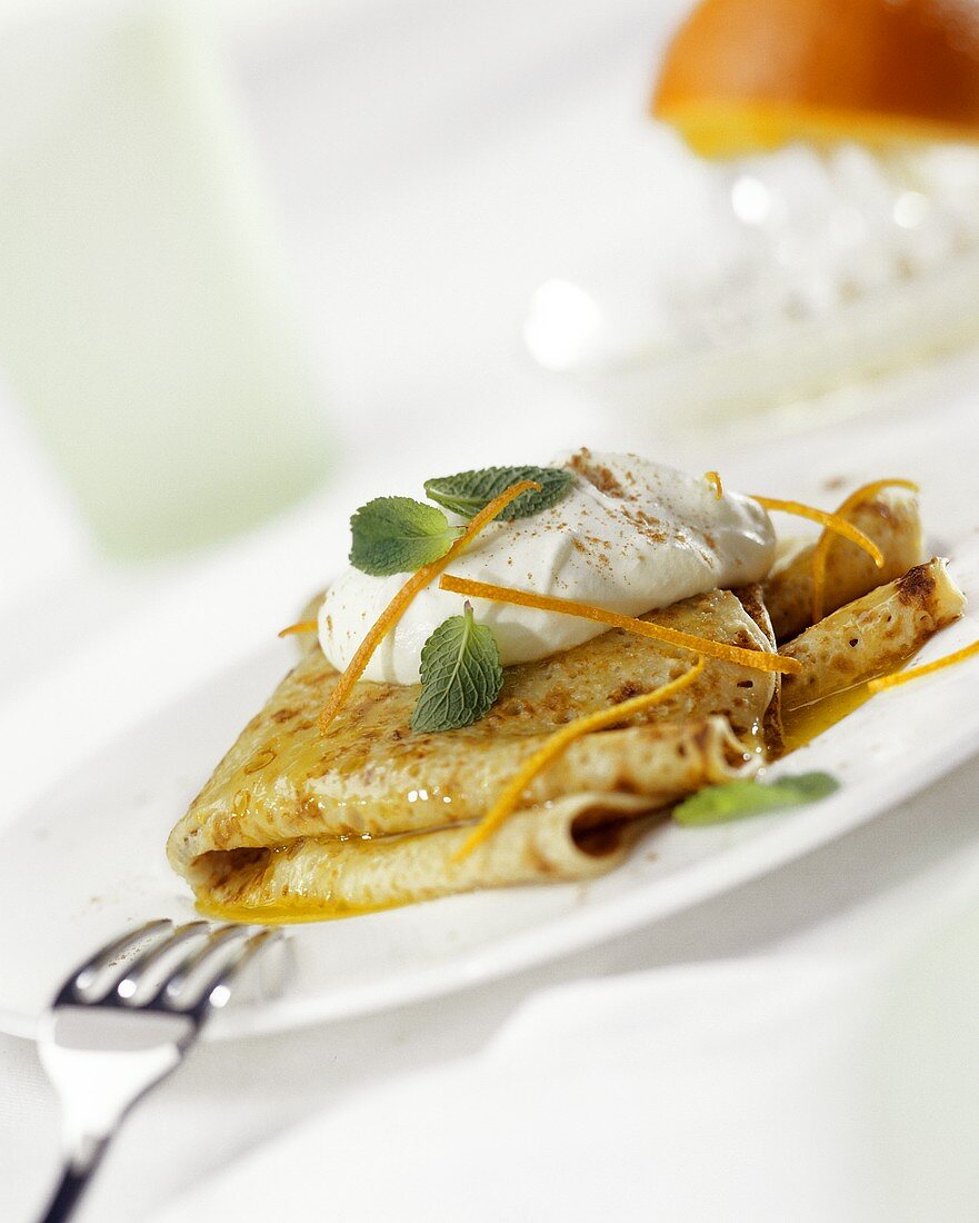 Crepes suzettes with cream and mint