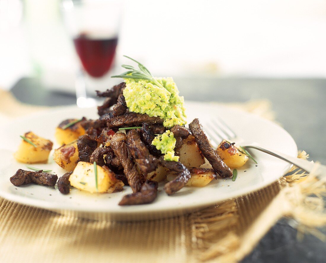 Beef fillet with bacon, roast potatoes and avocado puree