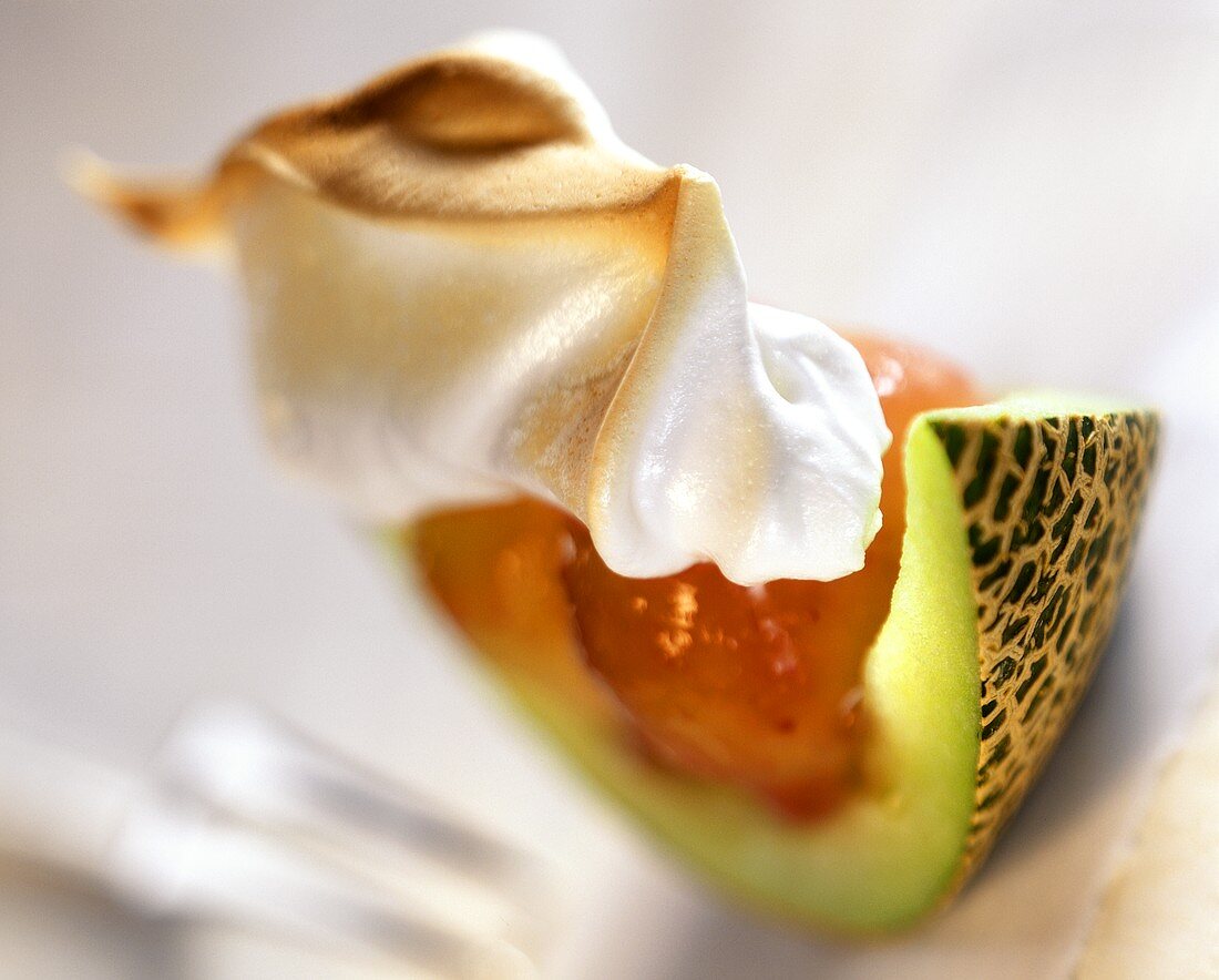 Melon wedge with strawberry puree and meringue