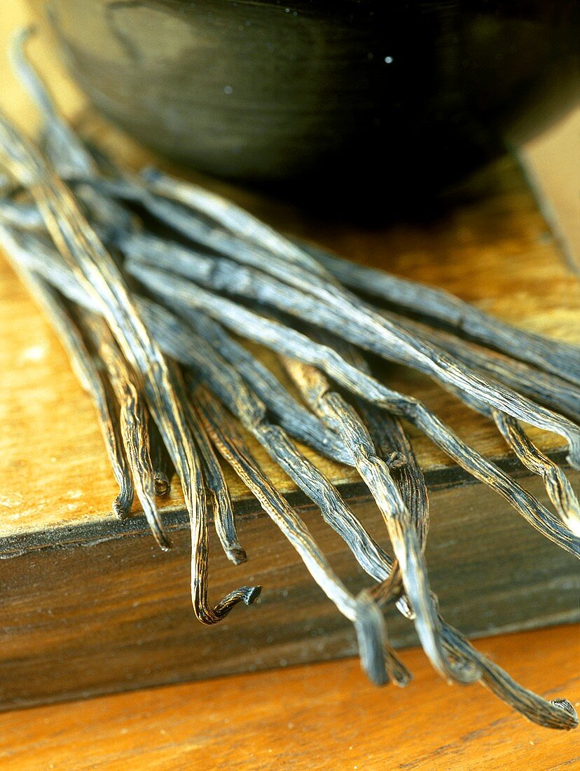 Vanilla pods on wooden crate