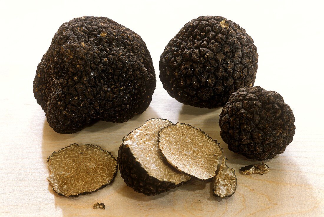 Black summer truffle on wood