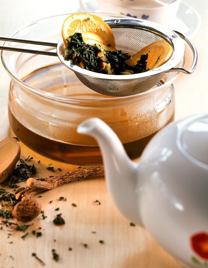 Fruit tea in sieve and teapot