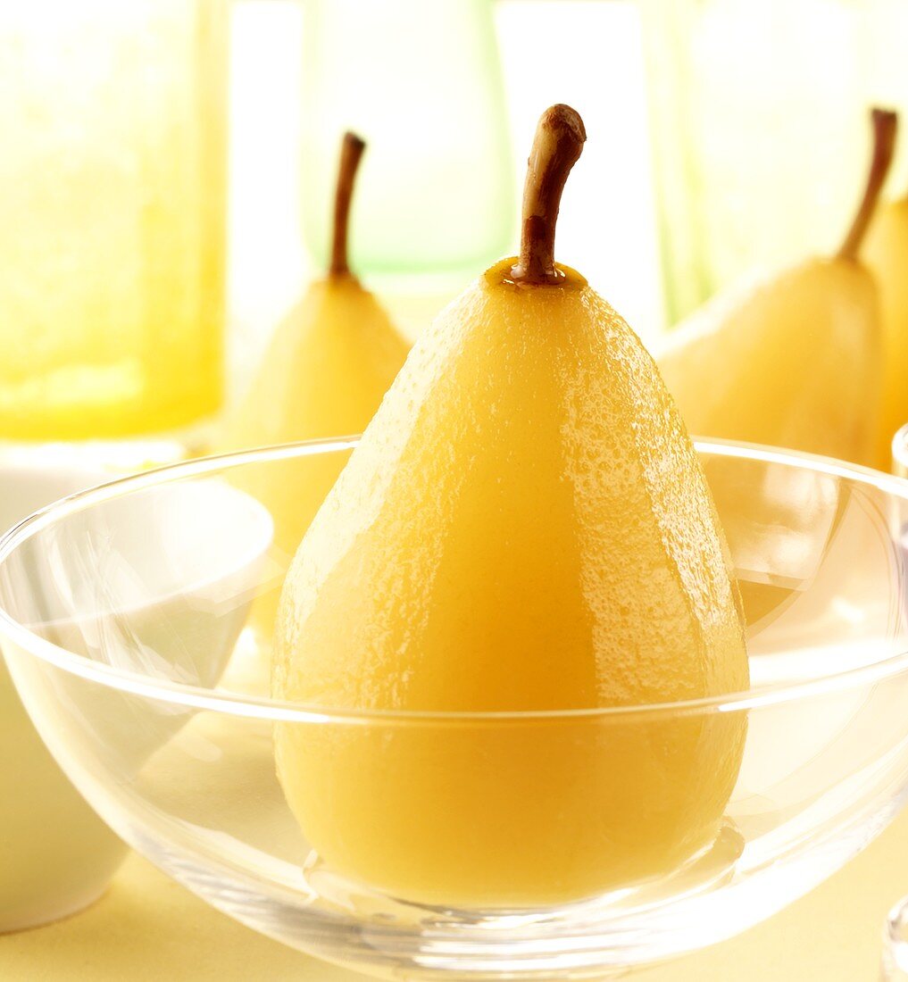 Poached pear in glass bowl