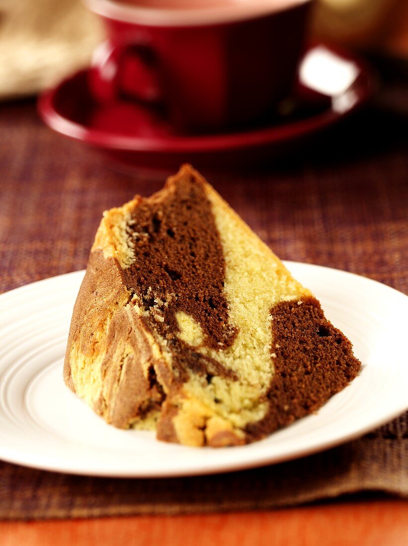 Piece of marble cake on white plate