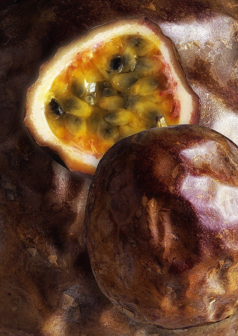 Passion fruit, halved against background of passion fruits
