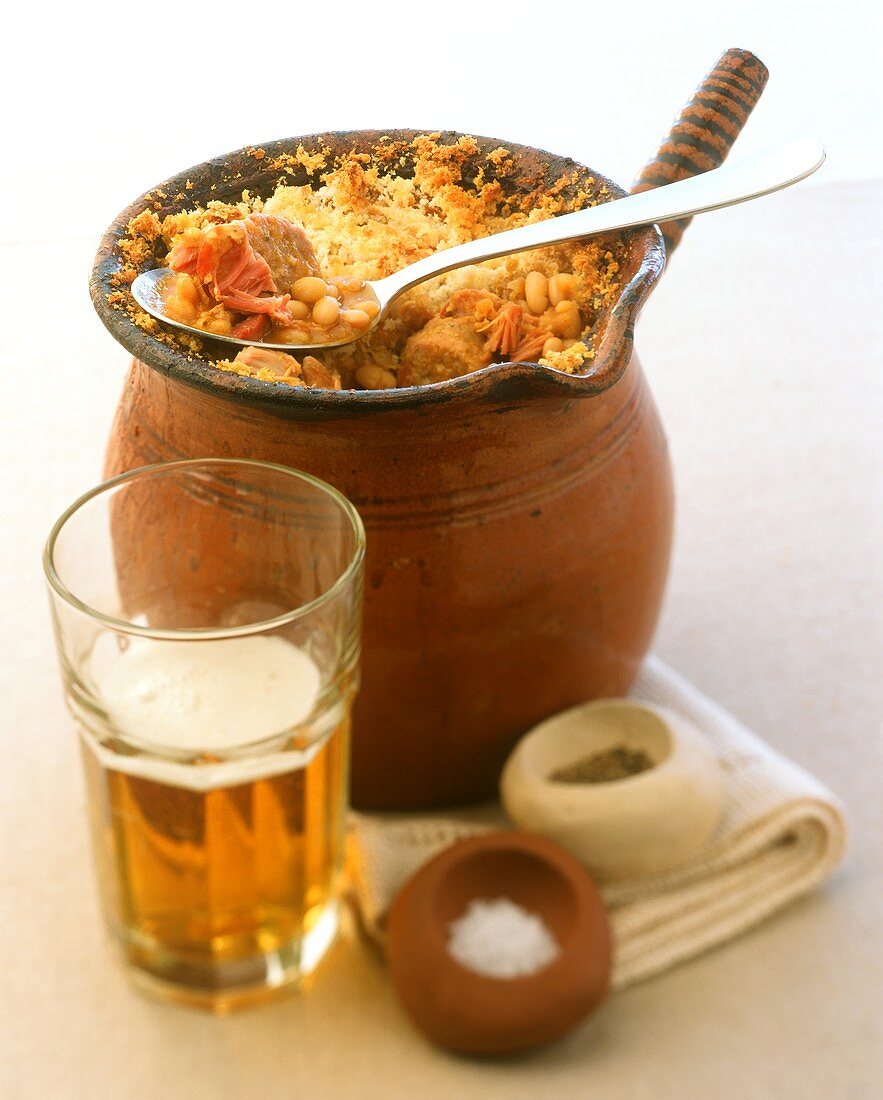English cassoulet in terracotta pot, beer and spices
