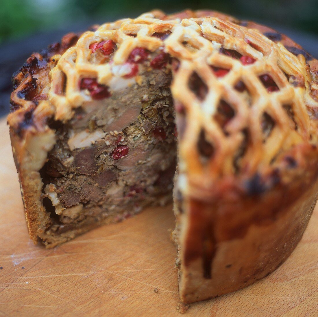 Venison pie with cranberries, a piece cut