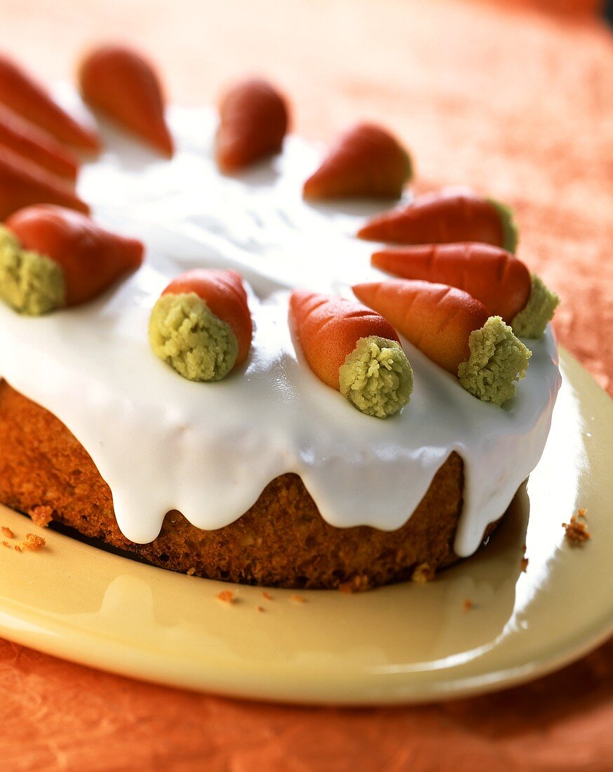 Carrot cake with glacé icing and marzipan carrots