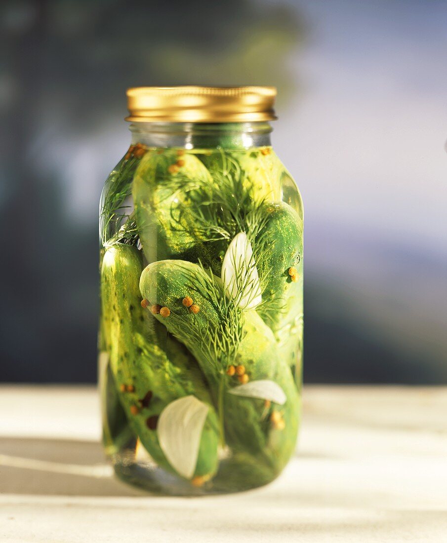 Dill pickles in a preserving jar