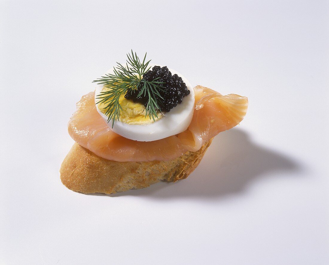 Canapé with salmon, egg and caviare