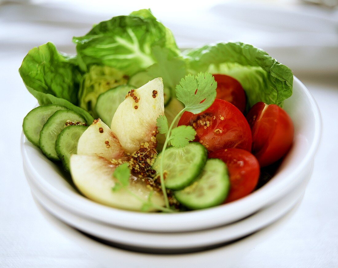 Colourful salad with peach and mustard dressing