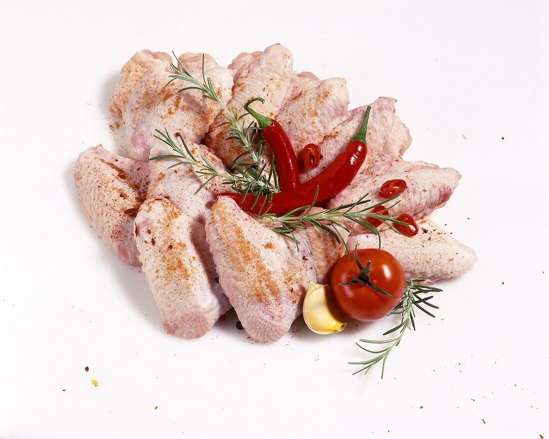 Chicken wings with chilis, rosemary and tomato