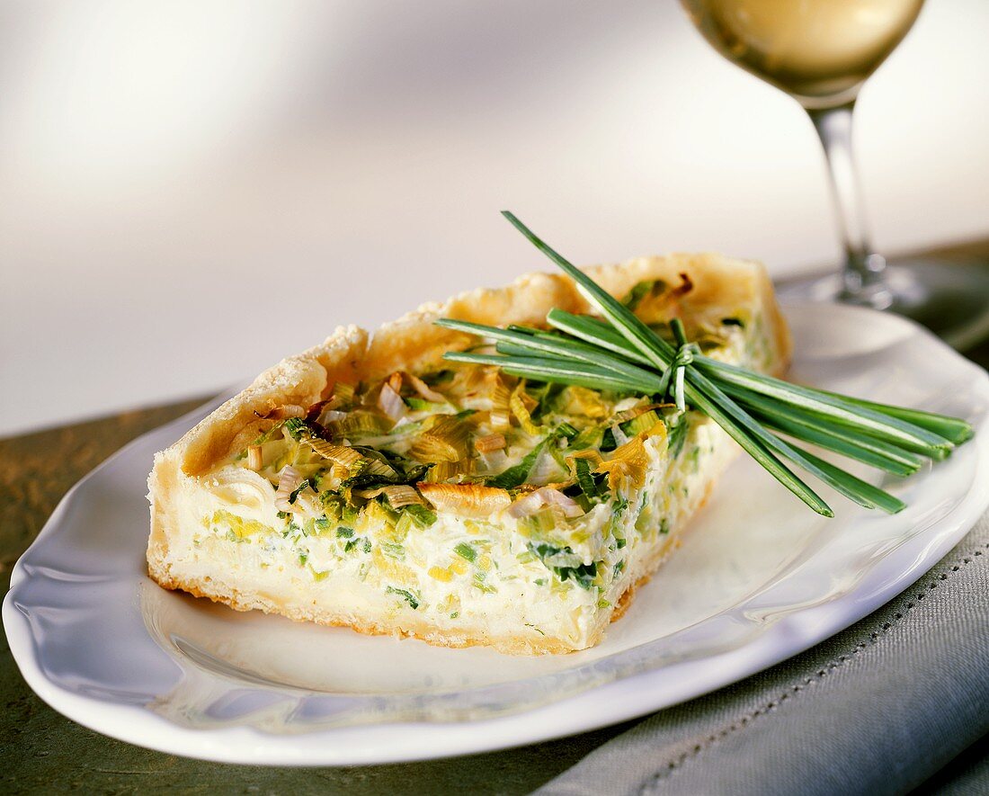 Piece of leek tart on white plate