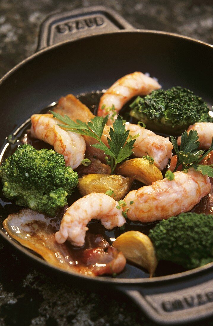 Fried scampi with garlic, broccoli and bacon