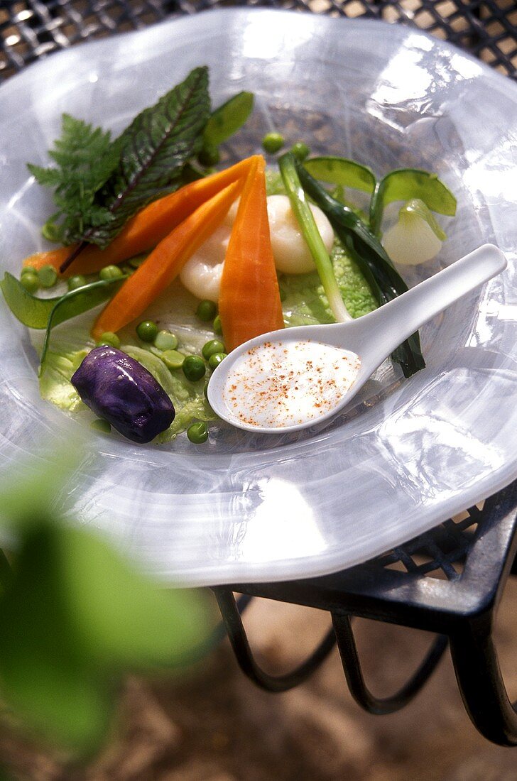 Plate of vegetables with carrots, peas & white sauce