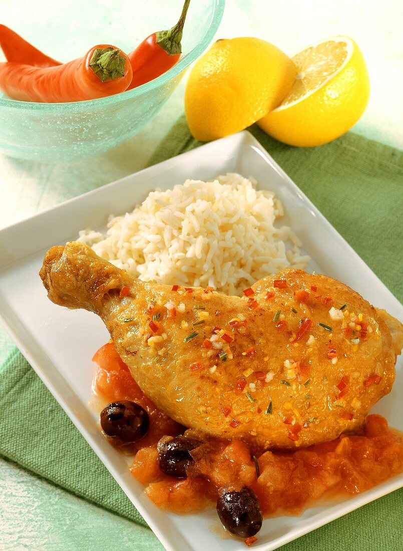 Chicken leg with tomatoes, olives and rice