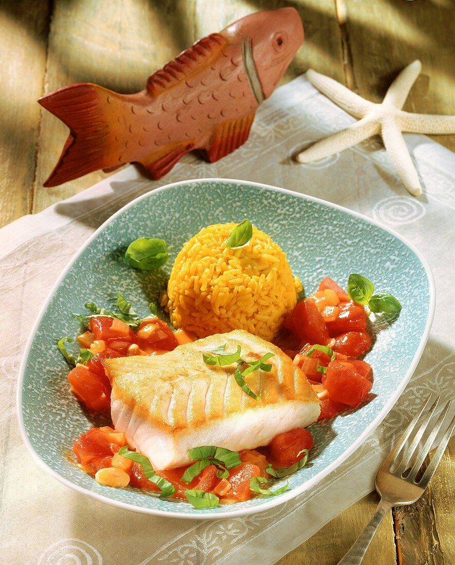 Fish fillet with saffron rice, tomatoes and basil